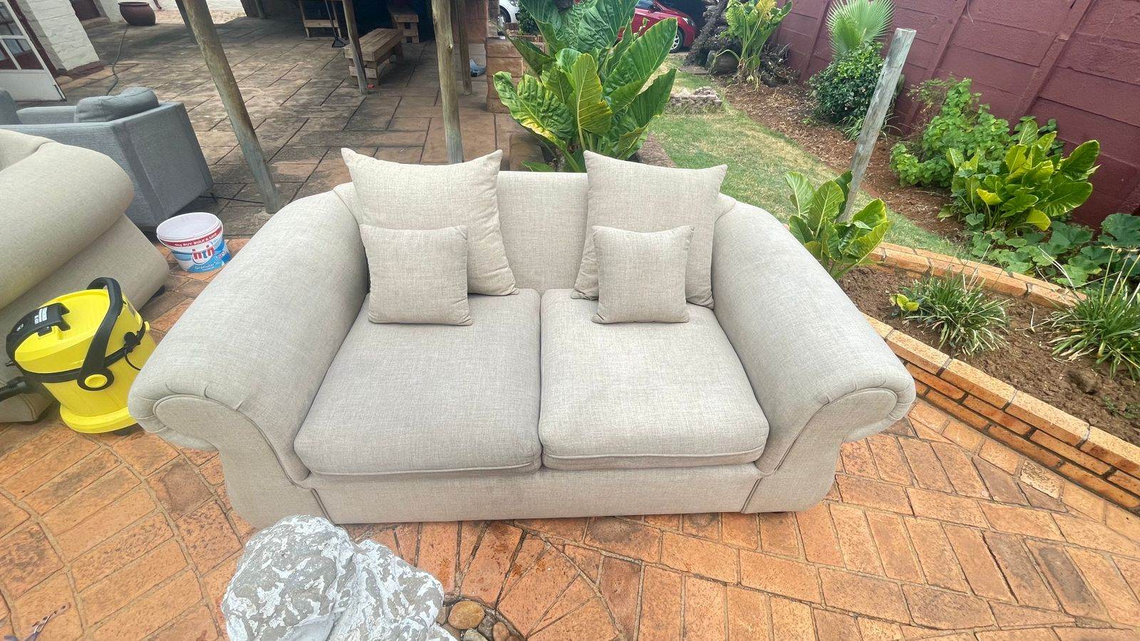 Maishire Fabrics extraction machine on site beside a sofa being cleaned in a Johannesburg garden